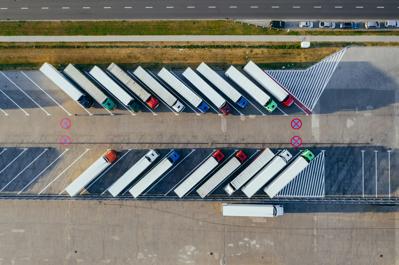 Fleet trucks parked at a logistics warehouse
